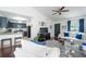 Open-concept living area features wood floors, neutral walls, and a breakfast bar connected to the kitchen at 2305 Keenland Ct, Cumming, GA 30040