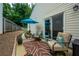 Relaxing outdoor patio featuring comfortable seating, an umbrella, and a stylish rug, perfect for enjoying outdoor living at 2305 Keenland Ct, Cumming, GA 30040