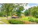 Green backyard surrounded by trees, showcasing an outdoor living space and landscaping at 2696 Eldorado Pl, Snellville, GA 30078