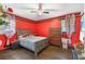 Cozy bedroom boasts bold red walls and hardwood floors at 2696 Eldorado Pl, Snellville, GA 30078