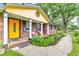 Inviting front porch with colorful door, fresh flowers, and comfortable seating at 2696 Eldorado Pl, Snellville, GA 30078