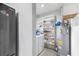 Functional laundry room with washer, dryer, shelving, and plenty of storage space at 2696 Eldorado Pl, Snellville, GA 30078