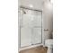 Modern walk-in shower with glass door, safety bars, and tiled walls at 6107 Malloway Ct # B-6107, Cumming, GA 30041