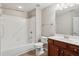 Clean bathroom featuring a combined bathtub and shower with tile surround at 6107 Malloway Ct # B-6107, Cumming, GA 30041