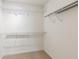 Walk-in closet featuring wire shelving, ample storage and neutral carpet at 6107 Malloway Ct # B-6107, Cumming, GA 30041