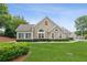 Charming home with manicured lawn, stone accents, and arched windows at 6107 Malloway Ct # B-6107, Cumming, GA 30041