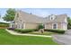 Beautiful home featuring manicured lawn, stone details, and arched windows at 6107 Malloway Ct # B-6107, Cumming, GA 30041