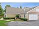 Home featuring a two-car garage and neutral siding and stone accents at 6107 Malloway Ct # B-6107, Cumming, GA 30041
