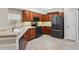 Well-equipped kitchen with black appliances, countertops, and abundant cabinet space at 6107 Malloway Ct # B-6107, Cumming, GA 30041