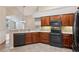 Updated kitchen with dark wood cabinets, stainless steel appliances, and stylish countertops at 6107 Malloway Ct # B-6107, Cumming, GA 30041