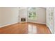 Cozy living room featuring a fireplace, soaring ceilings, and hardwood floors at 6107 Malloway Ct # B-6107, Cumming, GA 30041
