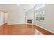 Well-lit living room with fireplace, tall ceilings, and hardwood floors at 6107 Malloway Ct # B-6107, Cumming, GA 30041