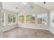 Bright sunroom with large windows, vaulted ceilings, and tile flooring at 6107 Malloway Ct # B-6107, Cumming, GA 30041