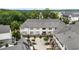 Aerial view of modern townhouses with two-car garages and a dense tree line in the background at 6613 Encore Blvd, Atlanta, GA 30328