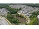 Community aerial view showcases clustered townhomes, a pond, and nearby commercial development at 6613 Encore Blvd, Atlanta, GA 30328
