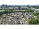 Aerial view of a community with townhomes amidst trees, with commercial buildings visible in the skyline at 6613 Encore Blvd, Atlanta, GA 30328