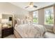 Cozy bedroom featuring a luxurious bed, soft lighting, and large windows with natural light at 6613 Encore Blvd, Atlanta, GA 30328