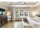 Bedroom featuring wood floors, large windows, a sitting bench, and view through to the hallway at 6613 Encore Blvd, Atlanta, GA 30328