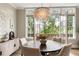 Charming dining room features a modern chandelier, a dark table, bright natural light, and access to a balcony at 6613 Encore Blvd, Atlanta, GA 30328