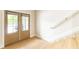 Bright entryway featuring wood-look flooring, a staircase, and a glass panel door that offers abundant natural light at 6613 Encore Blvd, Atlanta, GA 30328
