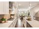 Bright and modern kitchen with gas cooktop, quartz counters, an island sink, and white cabinets, connected to the dining area at 6613 Encore Blvd, Atlanta, GA 30328