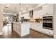 Stylish kitchen with white cabinets, stainless steel appliances, a central island and an open view to the living area at 6613 Encore Blvd, Atlanta, GA 30328