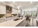 Beautiful kitchen features a gas cooktop, quartz counters, stainless vent hood, white cabinetry, and an open dining area at 6613 Encore Blvd, Atlanta, GA 30328