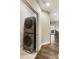 Hallway laundry closet equipped with a modern, stacked washer and dryer set and wood floors at 6613 Encore Blvd, Atlanta, GA 30328