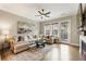 Cozy living room with comfortable seating, fireplace, television, and lots of natural light at 6613 Encore Blvd, Atlanta, GA 30328