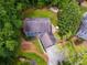 Aerial view of a home with mature trees and a large backyard and winding creek at 7250 Hunters Branch Dr, Atlanta, GA 30328