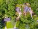 Overhead shot of a neighborhood showcasing mature landscaping and the winding creek at 7250 Hunters Branch Dr, Atlanta, GA 30328