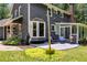 Outdoor patio with seating and grill, complemented by a covered porch and bay window at 7250 Hunters Branch Dr, Atlanta, GA 30328