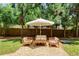 Relaxing backyard patio with comfortable furniture, an umbrella, and privacy trees at 7250 Hunters Branch Dr, Atlanta, GA 30328