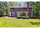 Expansive backyard featuring a stone patio and enclosed porch, perfect for outdoor gatherings at 7250 Hunters Branch Dr, Atlanta, GA 30328