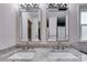 Elegant bathroom featuring granite counters, double sinks, and matching framed mirrors at 7250 Hunters Branch Dr, Atlanta, GA 30328