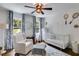 Charming Bedroom with soft colors, natural light, a comfortable rocking chair, and soothing decor at 7250 Hunters Branch Dr, Atlanta, GA 30328