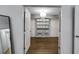 A beautiful and spacious closet with great storage, shelving, and a stunning light fixture at 7250 Hunters Branch Dr, Atlanta, GA 30328