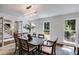 Light filled dining room featuring a hardwood floor, pendant lighting, and bright windows at 7250 Hunters Branch Dr, Atlanta, GA 30328