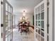 Elegant dining room with stylish chandelier and a dining table set for a formal meal, viewed through glass doors at 7250 Hunters Branch Dr, Atlanta, GA 30328