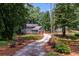 Charming blue two-story home with lush greenery, a welcoming driveway, and an attached two-car garage at 7250 Hunters Branch Dr, Atlanta, GA 30328