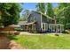 A beautiful home exterior with a large yard, established trees, and a spacious patio at 7250 Hunters Branch Dr, Atlanta, GA 30328