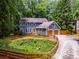 Charming blue two-story home with a well-manicured lawn, inviting curb appeal, and attached two car garage at 7250 Hunters Branch Dr, Atlanta, GA 30328