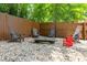 Great backyard firepit area with gravel base and Adirondack chairs surrounded by wood fence at 7250 Hunters Branch Dr, Atlanta, GA 30328