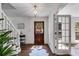 Sunlit foyer with hardwood floors, a staircase, and glass-paneled doors leading to other rooms at 7250 Hunters Branch Dr, Atlanta, GA 30328