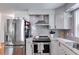 Modern kitchen featuring stainless appliances, white cabinets, and granite countertops at 7250 Hunters Branch Dr, Atlanta, GA 30328