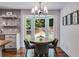 Charming breakfast nook with a round table, bay window, and modern light fixture at 7250 Hunters Branch Dr, Atlanta, GA 30328