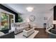 Bright living room with a comfortable sofa, large window, and hardwood floors at 7250 Hunters Branch Dr, Atlanta, GA 30328