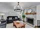 Cozy living room with stone fireplace, wood mantle, decorative lighting, and comfortable furniture at 7250 Hunters Branch Dr, Atlanta, GA 30328
