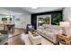 Cozy living room featuring hardwood floors, a modern sofa, and a black accent wall at 7250 Hunters Branch Dr, Atlanta, GA 30328