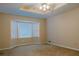 Bedroom with tray ceiling, fan, bay window, and neutral walls and carpet at 110 Fox Meadow Dr, Covington, GA 30016